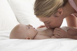 mother kissing baby