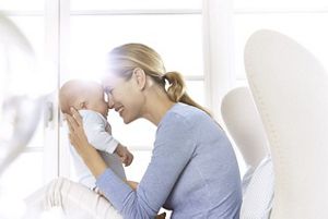 mother kissing baby
