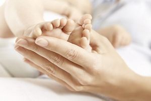 mother kissing babys feet