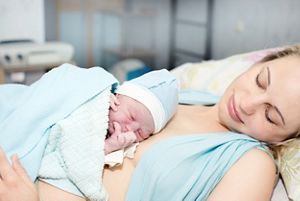 mother holding new born in hospital