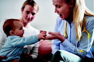 doctor playing with baby