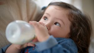 Baby Girl Drinking Milk From Bottle