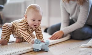 Baby Playing With Wooden Elephant
