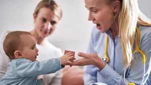 Baby With Mum And Nurse