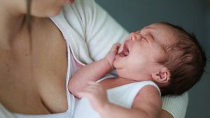 Crying Newborn In Mums Arms