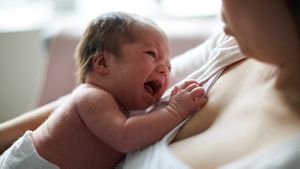 Crying Newborn On Mums Chest