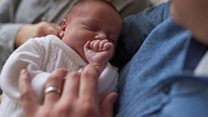 Dad Holding Sleeping Newborn