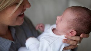 Mother Holding Premature Baby