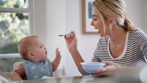 Mother Spoonfeeding Baby