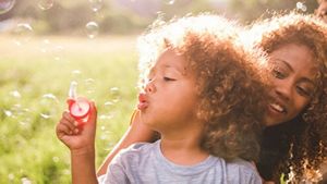 Toddler Blowing Soap Bubbles