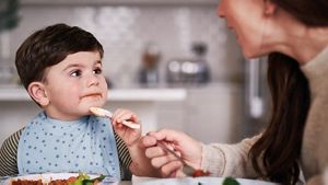Toddler Eating With Spoon