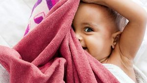 Toddler Hiding Under Blanket
