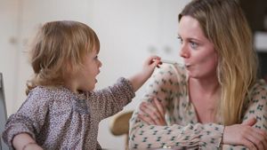 Toddler Spoon Feeding Mother