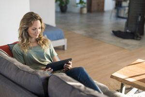 woman-on-couch-with-tablet.png