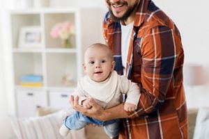 happy father with little baby boy at home