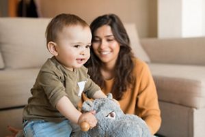 Baby playing with a rocking horse