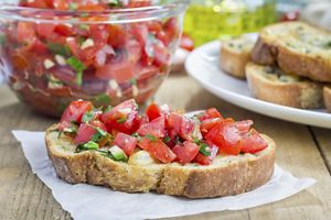 Bruschetta with tomatoes, herbs and oil on toasted garlic cheese bread