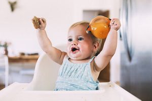 toddler-holding-beaker-air