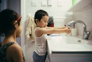 little boy and girl washing hands