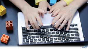 mother-and-baby-hands-laptop