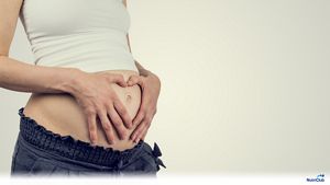 woman-second-trimester-hands-on-belly