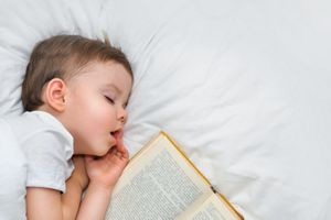 Boy sleeps with book