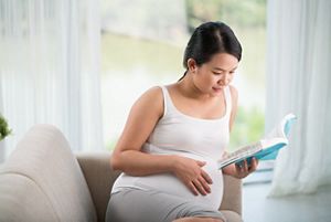 pregnant-reading-on-couch.jpg